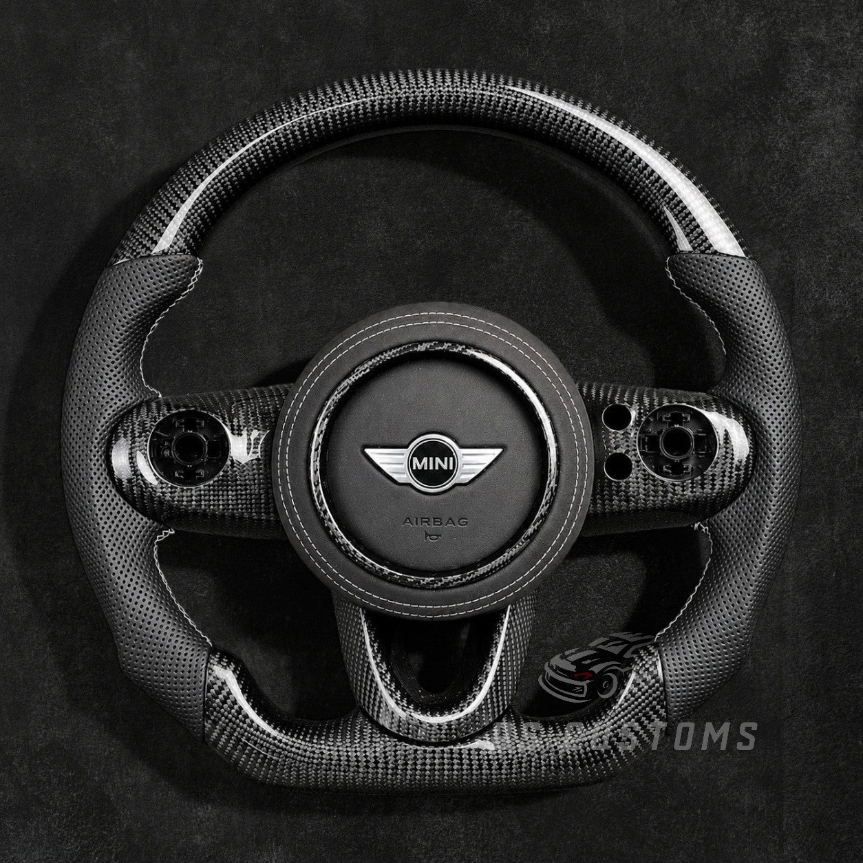 Custom MINI Cooper carbon fiber steering wheel for F54 F55 F56 F57 F60 with glossy carbon fiber top and bottom, perforated leather grips and sporty OEM+ design.
