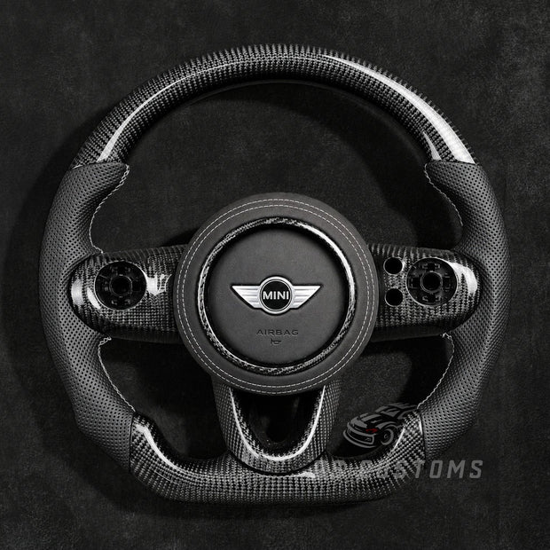 Custom MINI Cooper carbon fiber steering wheel for F54 F55 F56 F57 F60 with glossy carbon fiber top and bottom, perforated leather grips and sporty OEM+ design.