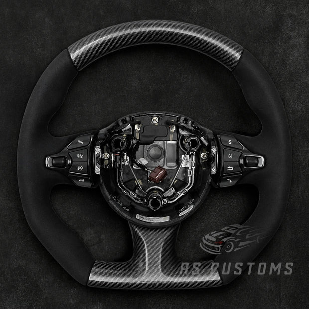 RS CUSTOMS Aston Martin carbon fiber and Alcantara steering wheel with flat top and bottom, Vulcan style.