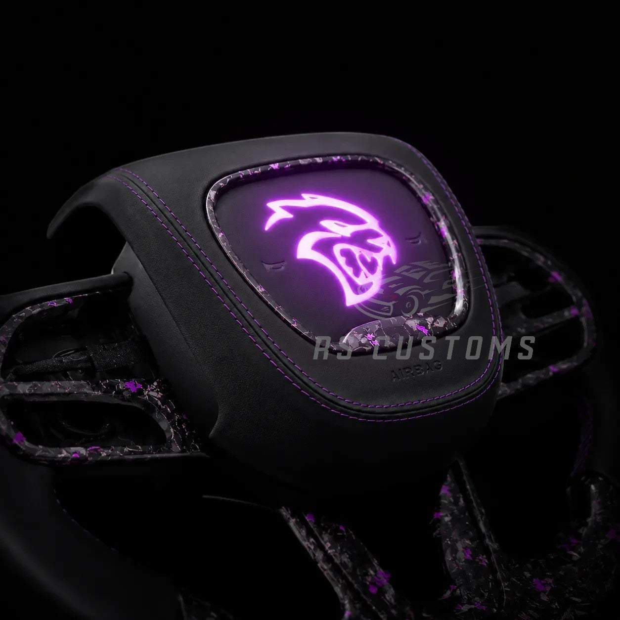 RS CUSTOMS custom carbon fiber steering wheel with Alcantara grips and purple illuminated Hellcat logo for Dodge/Jeep.
