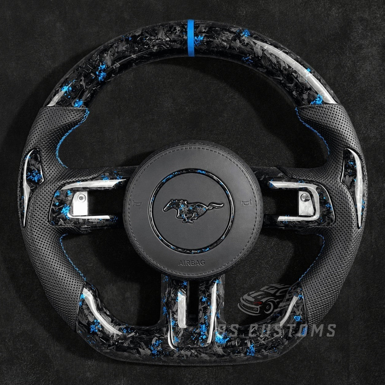 RS Customs 2015–2023 Ford Mustang custom flaked forged carbon fiber custom steering wheel with perforated leather grips and custom airbag cover with forged carbon logo.