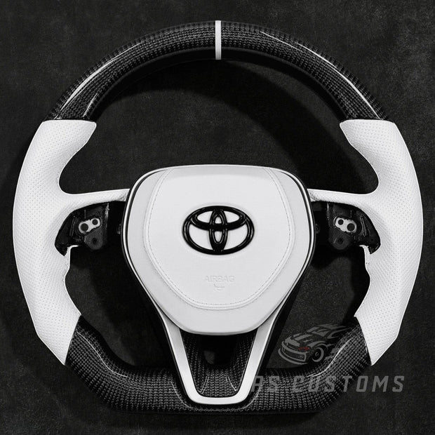 RS Customs 2018+ Toyota Corolla and Camry carbon fiber custom steering wheel with white leather grips and optional custom airbag cover in OEM+ sporty design.