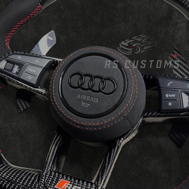 RS Customs Audi R8 and TT custom steering wheel with carbon fiber construction, Alcantara grips, carbon fiber trim, optional complete airbag and OEM functionality for Audi performance models.