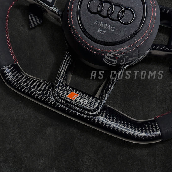 RS Customs Audi R8 and TT custom steering wheel with carbon fiber construction, Alcantara grips, carbon fiber trim, optional complete airbag and OEM functionality for Audi performance models.