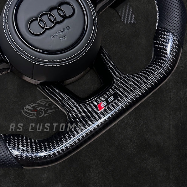 RS Customs Audi RS B9 custom steering wheel with carbon fiber, leather grips, custom center stripe and chrome delete trim for RS3, RS4, RS5, RS6, RS7 and other Audi models.