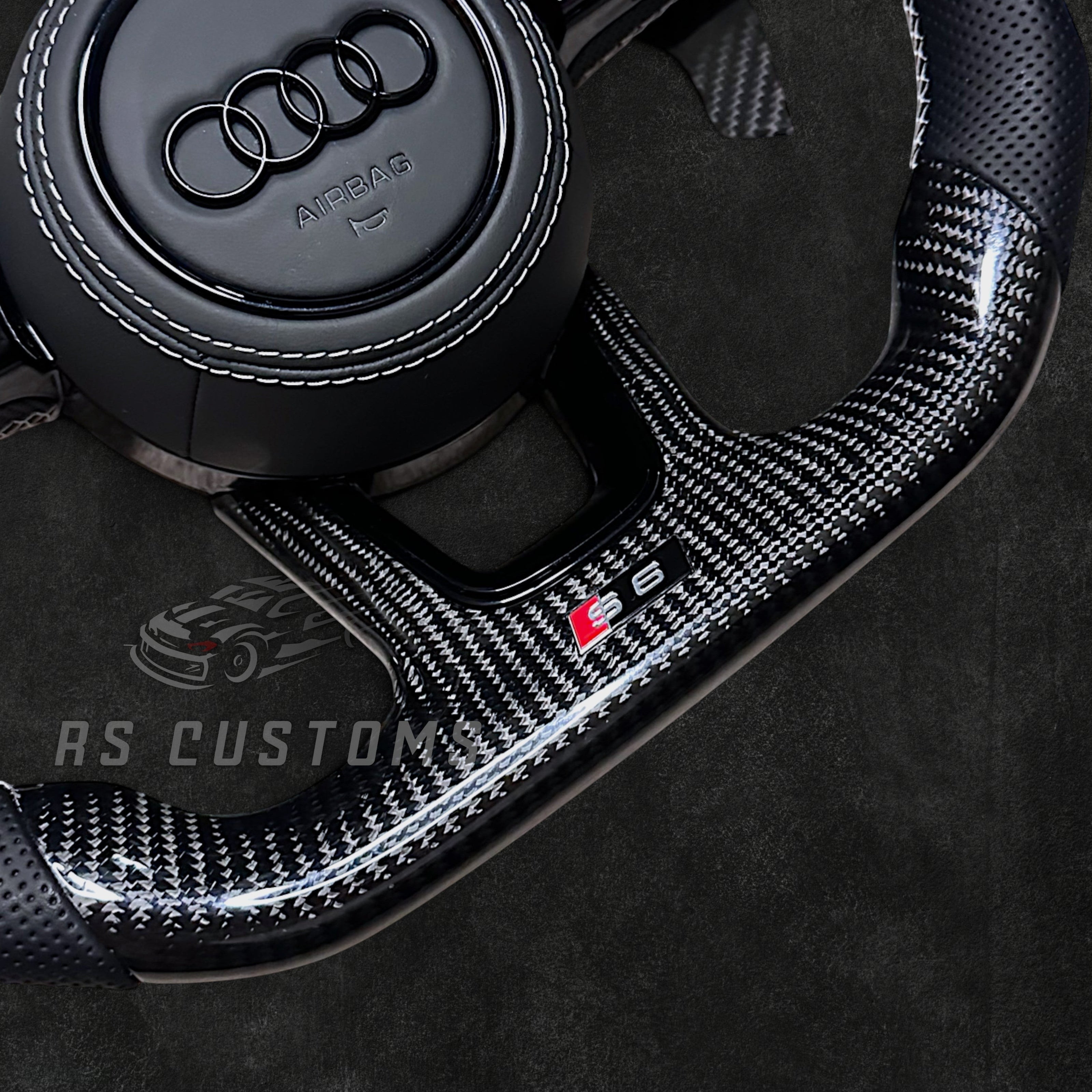 RS Customs Audi RS B9 custom steering wheel with carbon fiber, leather grips, custom center stripe and chrome delete trim for RS3, RS4, RS5, RS6, RS7 and other Audi models.