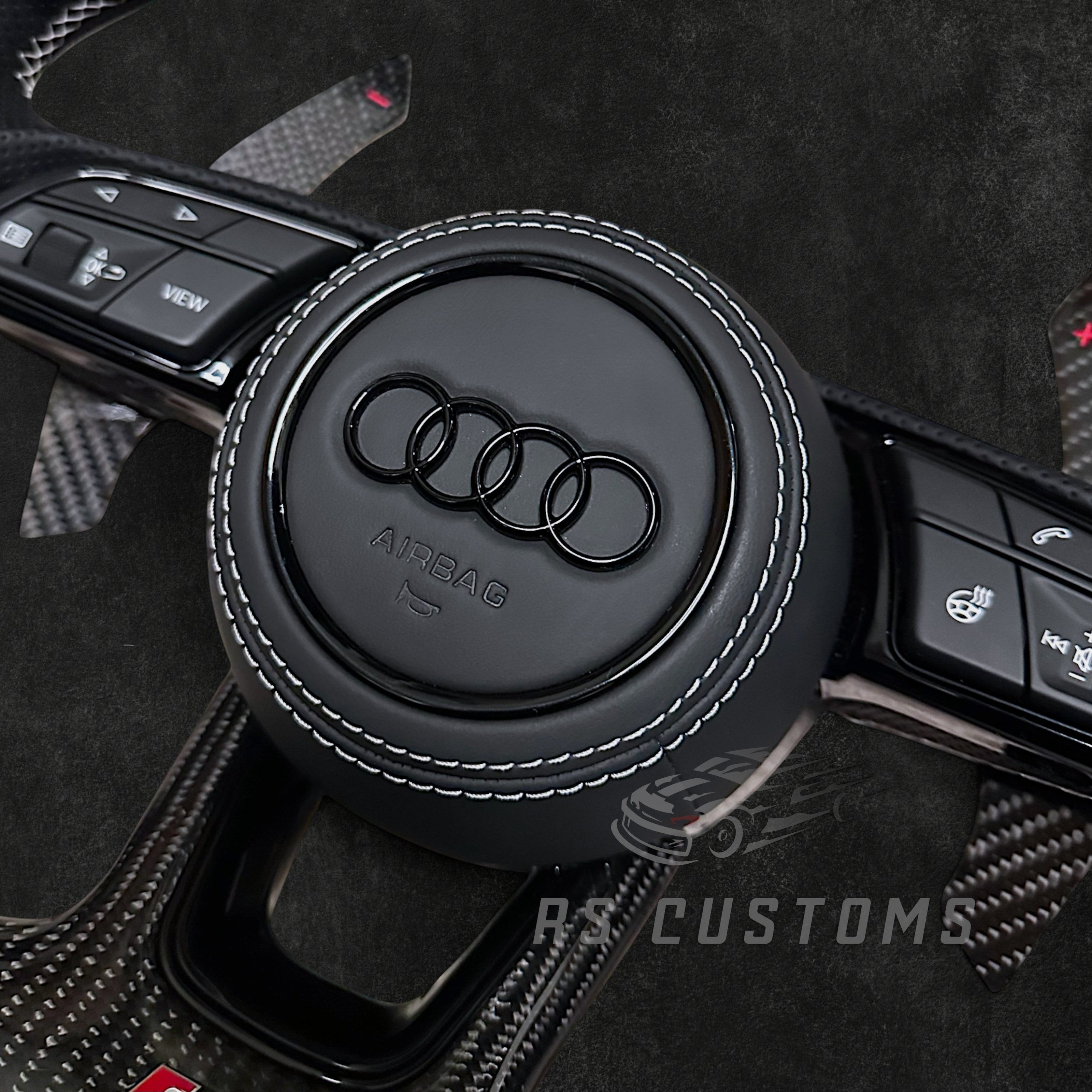 RS Customs Audi RS B9 custom steering wheel with carbon fiber, leather grips, custom center stripe and chrome delete trim for RS3, RS4, RS5, RS6, RS7 and other Audi models.