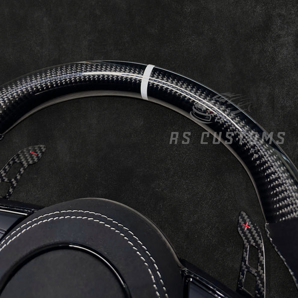 RS CUSTOMS Audi RS steering wheel with carbon fiber, Alcantara, and white stitching. Features a white stripe at 12 o'clock.