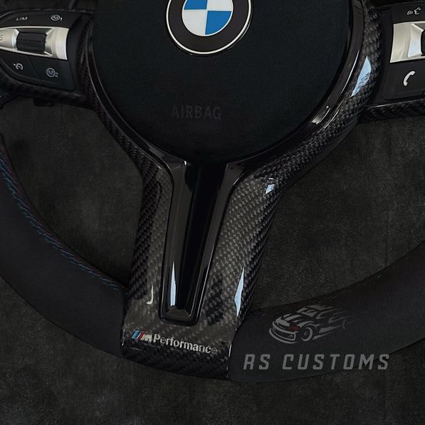 RS Customs BMW F-Series CS-style custom steering wheel with Alcantara, CS stripe, carbon fiber trim, optional Alcantara airbag cover, heating support and paddle shifter compatibility.