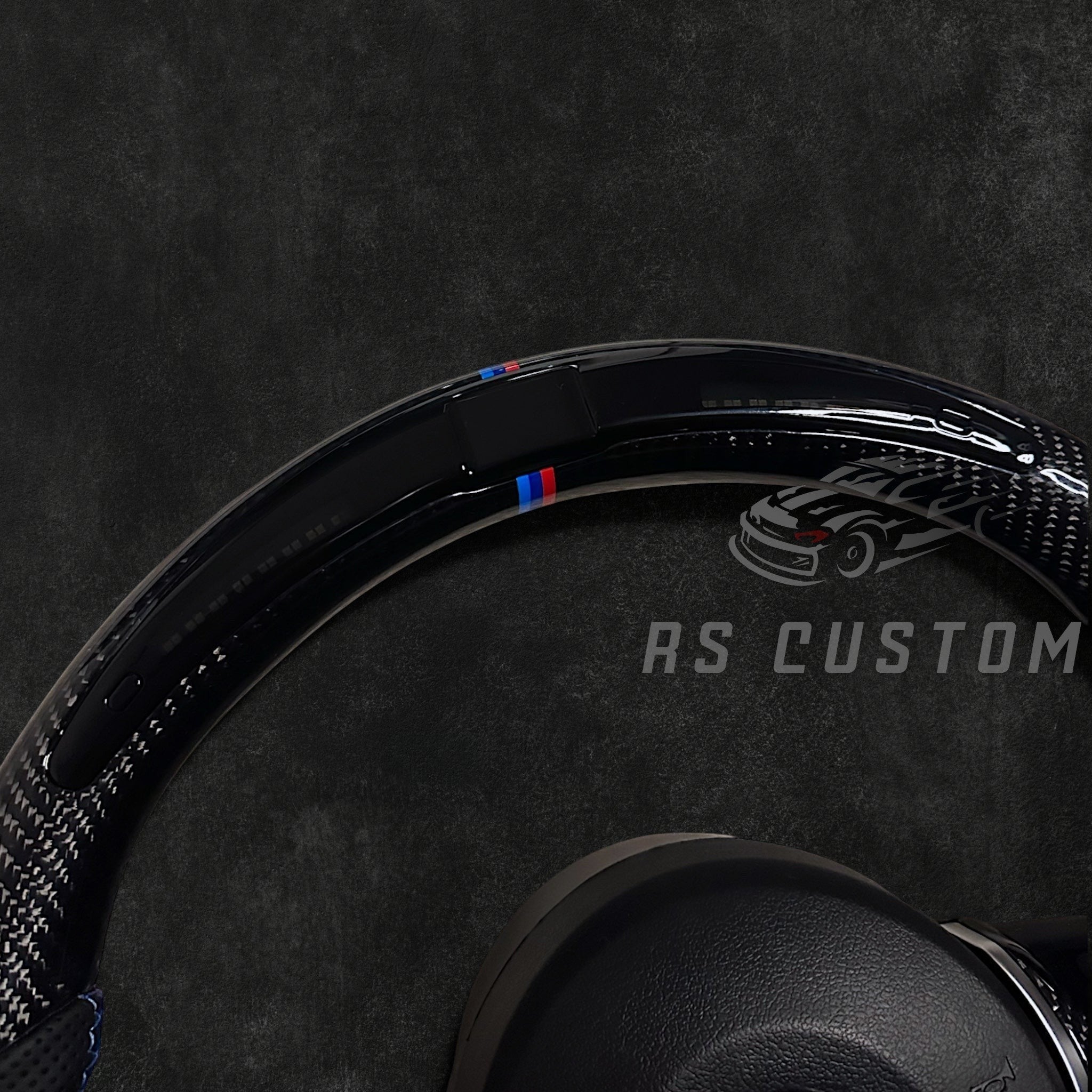 RS Customs BMW F-Series custom steering wheel with carbon fiber, leather grips, integrated LED display, optional complete airbag, multifunction buttons, heating and paddle shifters.