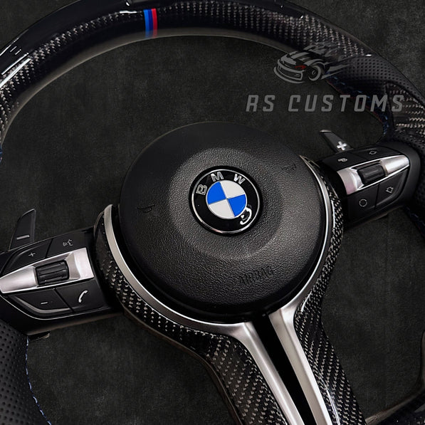 RS Customs BMW F-Series custom steering wheel with carbon fiber, leather grips, integrated LED display, optional complete airbag, multifunction buttons, heating and paddle shifters.