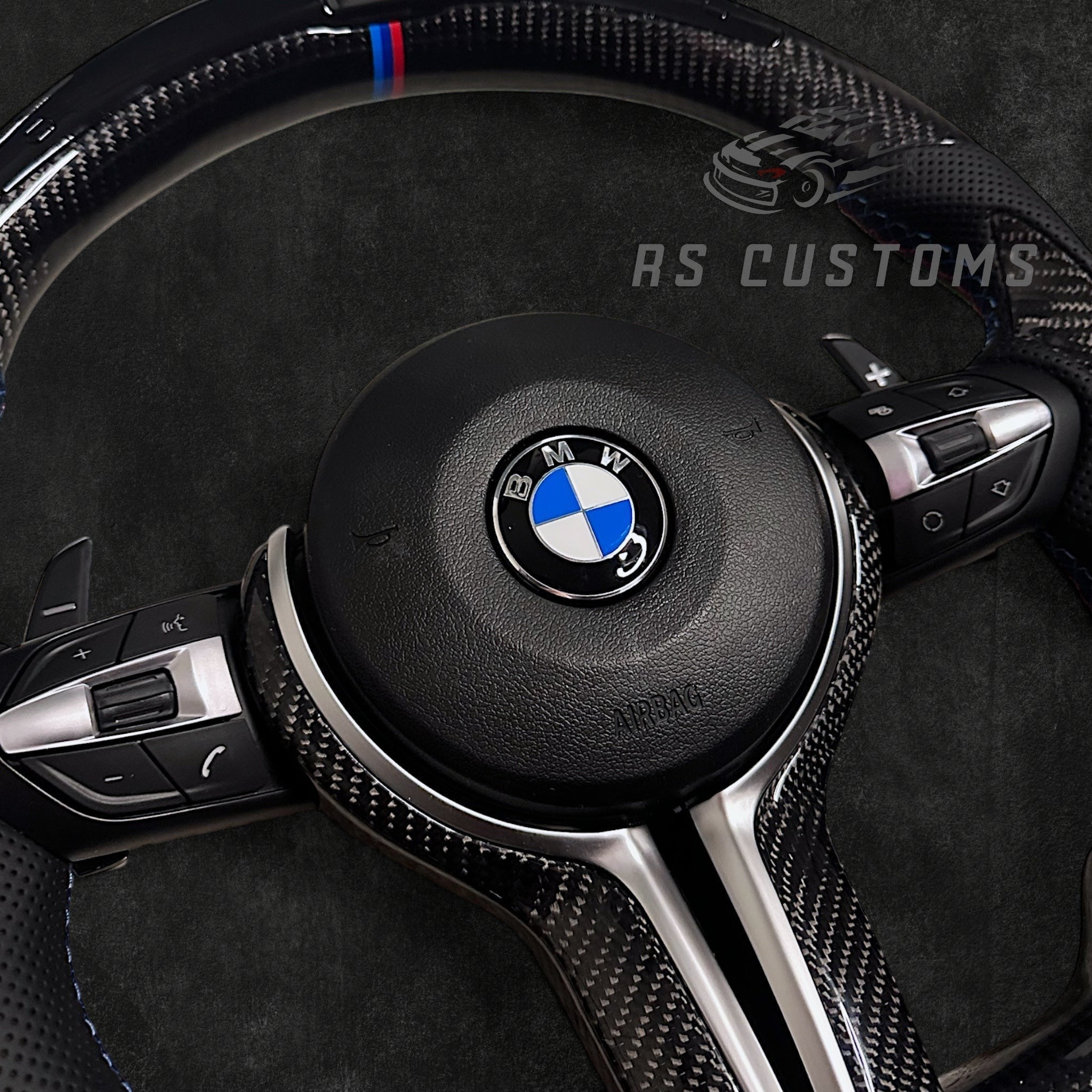 RS Customs BMW F-Series custom steering wheel with carbon fiber, leather grips, integrated LED display, optional complete airbag, multifunction buttons, heating and paddle shifters.