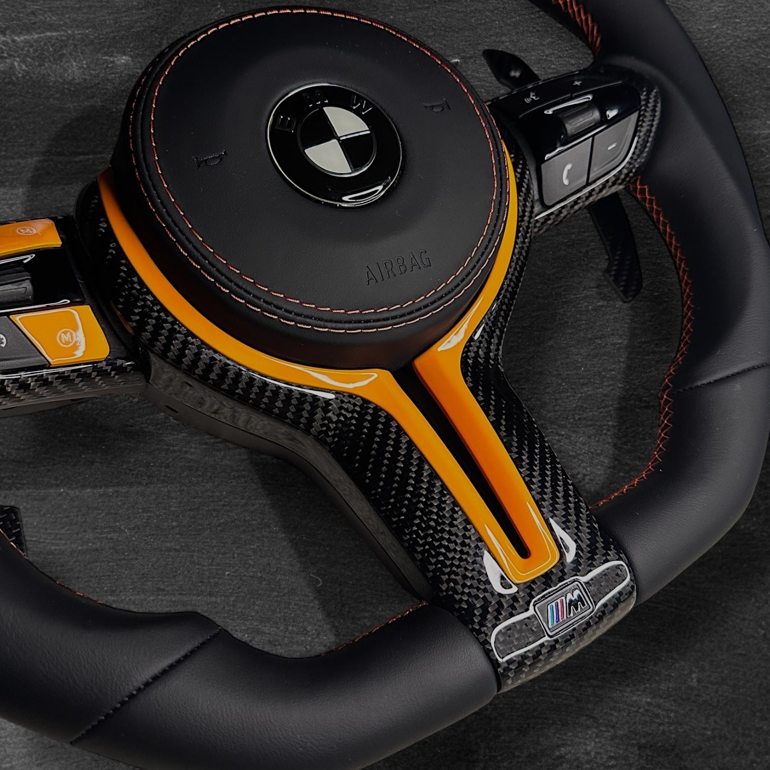 RS Customs BMW F-Series custom steering wheel with Nappa leather, carbon fiber trim, customizable colored accents, LED display, optional complete airbag, heating and paddle shifters.