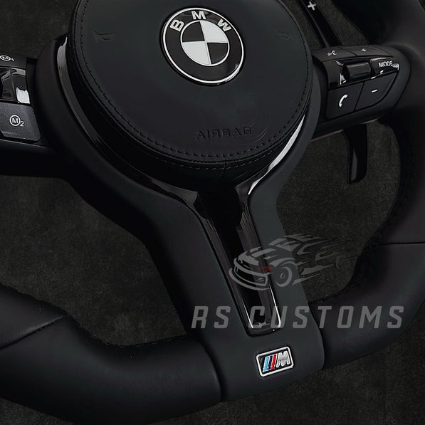 RS Customs BMW F-Series flat bottom leather steering wheel with black trim, heating, vibration support, paddle shifters and optional OEM or custom airbag.