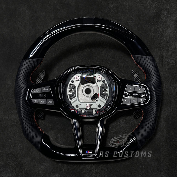 RS Customs BMW G-Series custom steering wheel with Piano Black trim, perforated leather grips, LED display, heating, ACC support, HOD sensor, vibration motor, paddle shifters and optional custom airbag.