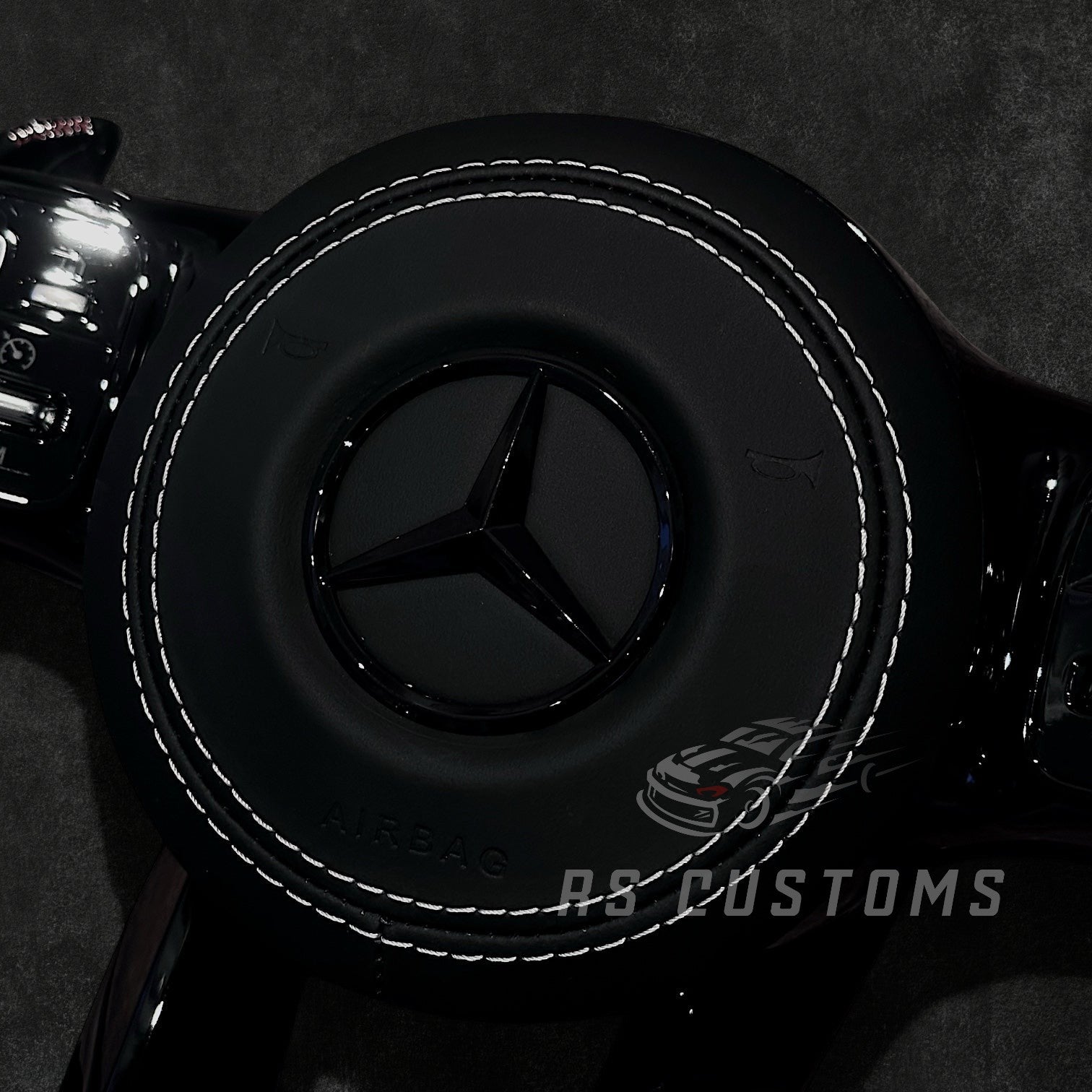 RS Customs Mercedes-Benz AMG Gen 4 custom steering wheel with full leather all-black design and leather airbag cover for W204, W205, W206, W212, W213, W222, W223, W463 and most Mercedes-Benz models from 2012+.