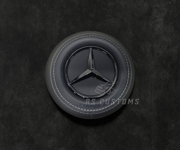 RS Customs Mercedes-Benz custom airbag cover for 2022+ models available in leather or Alcantara with custom stitching and chrome or black Mercedes-Benz logo options.