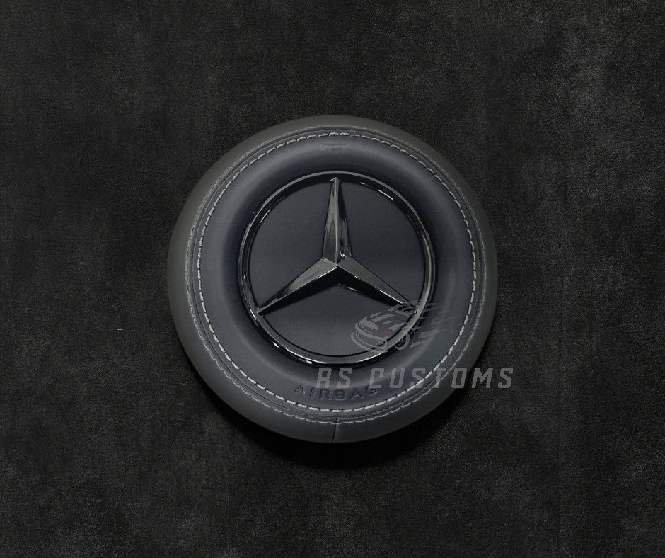 RS Customs Mercedes-Benz custom airbag cover for 2022+ models available in leather or Alcantara with custom stitching and chrome or black Mercedes-Benz logo options.