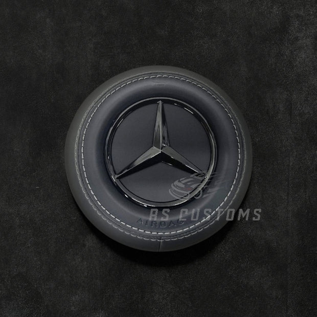 RS Customs Mercedes-Benz custom airbag cover for 2022+ models available in leather or Alcantara with custom stitching and chrome or black Mercedes-Benz logo options.