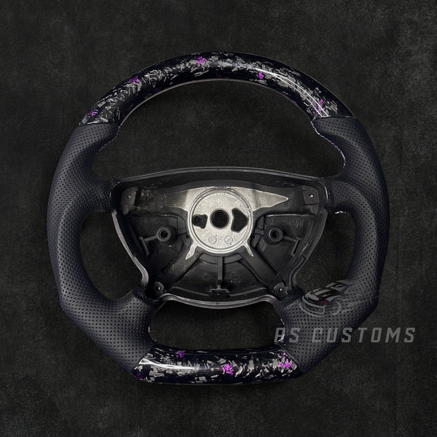RS Customs Mercedes-Benz W211 custom steering wheel with forged carbon fiber, customizable colored flakes and premium leather grips for E-Class and AMG models.