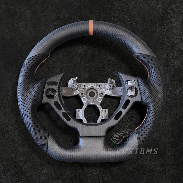 RS Customs Nissan GT-R R35 Pre-Facelift custom steering wheel with carbon fiber, perforated leather grips and optional leather or Alcantara airbag cover for 2008–2016 GT-R models.
