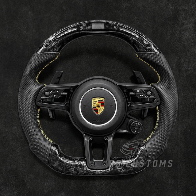 RS Customs Porsche custom steering wheel with forged carbon fiber, perforated leather, LED display, multifunction buttons and optional custom airbag for 911, Cayman, Boxster, Macan, Cayenne and Panamera models.
