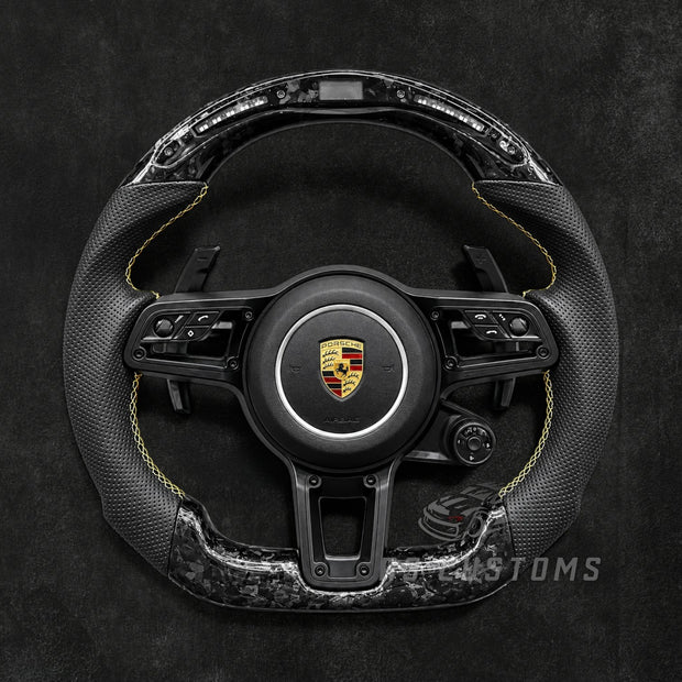 RS Customs Porsche custom steering wheel with forged carbon fiber, perforated leather, LED display, multifunction buttons and optional custom airbag for 911, Cayman, Boxster, Macan, Cayenne and Panamera models.