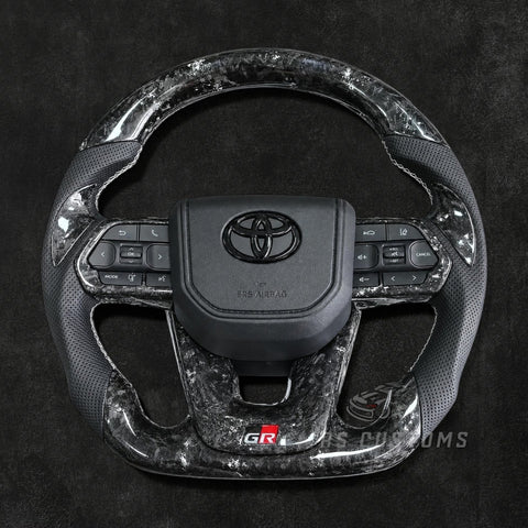 RS Customs Toyota Land Cruiser GR custom steering wheel with forged carbon fiber, colored flakes, perforated leather grips, forged carbon trim and optional custom airbag cover.