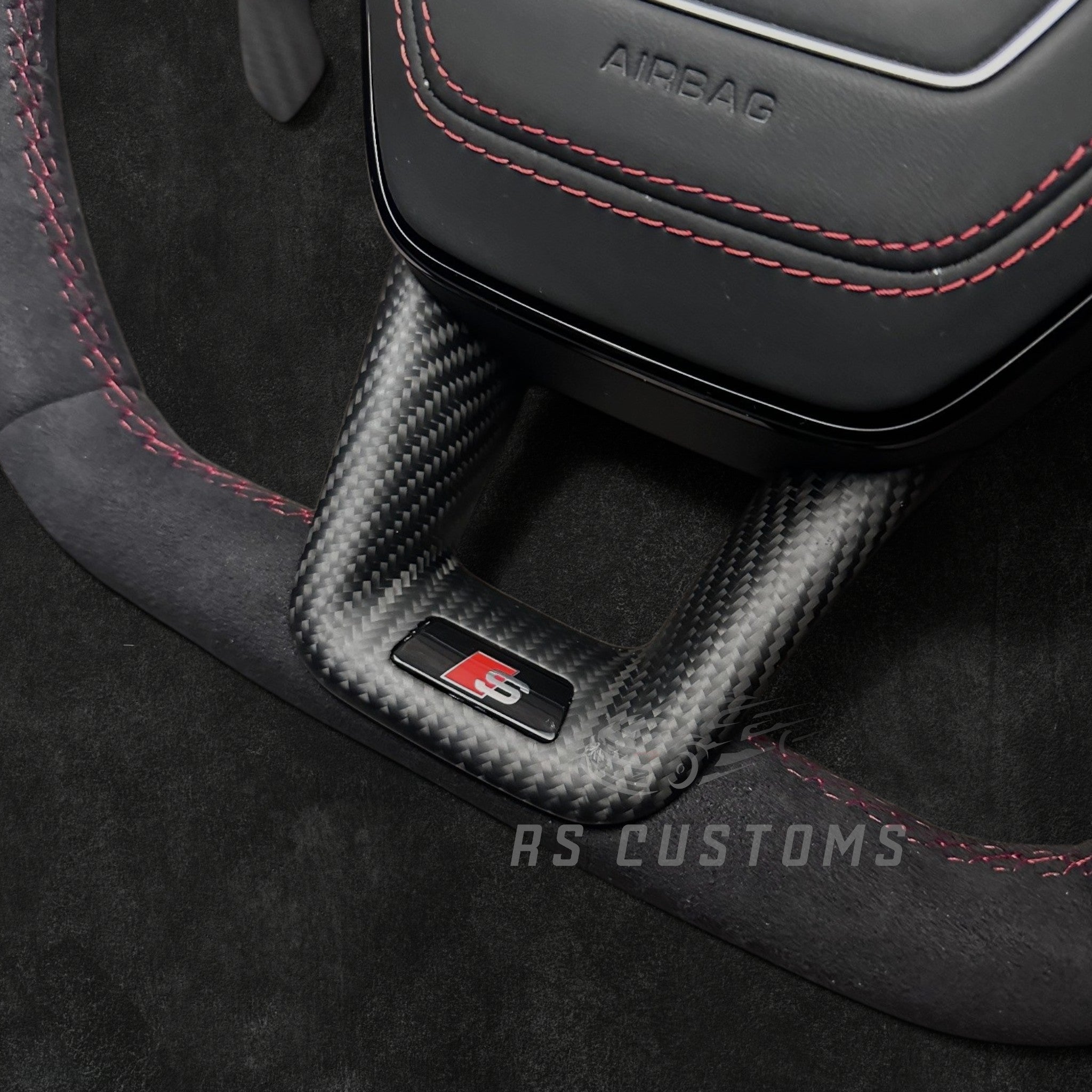 RS CUSTOMS Audi RS C8 flat bottom steering wheel with Alcantara, carbon fiber trim, and red stitching.