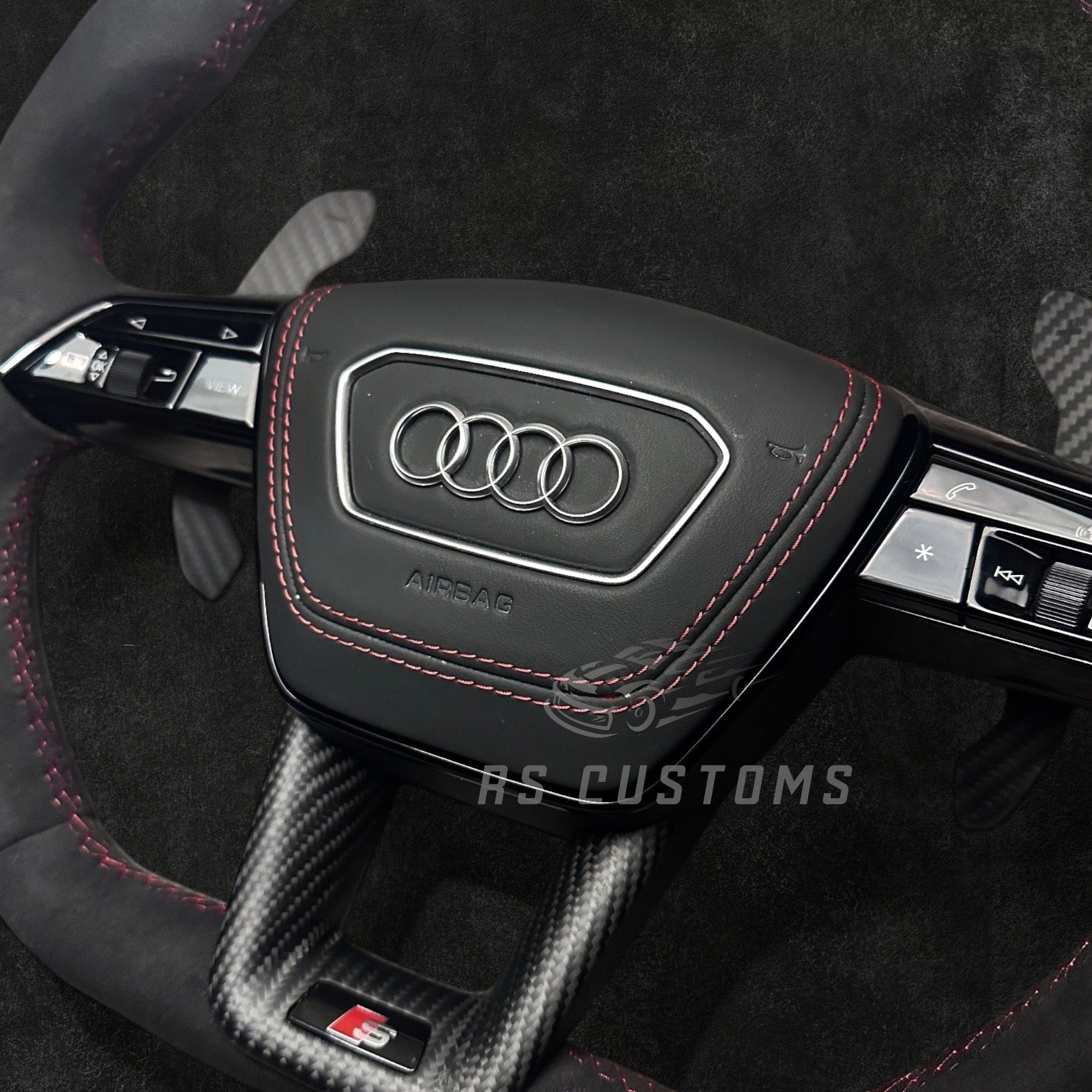 RS CUSTOMS Audi RS C8 flat bottom steering wheel in black Alcantara with red stitching and carbon fiber trim.