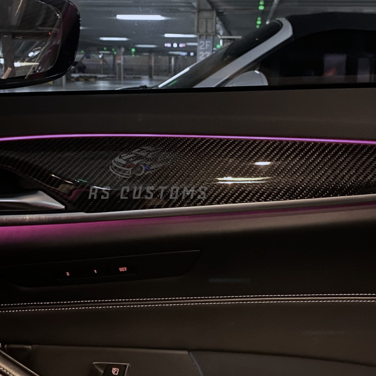 RS CUSTOMS carbon fiber interior trim kit for cars, featuring a distinctive weave pattern and high-gloss finish.