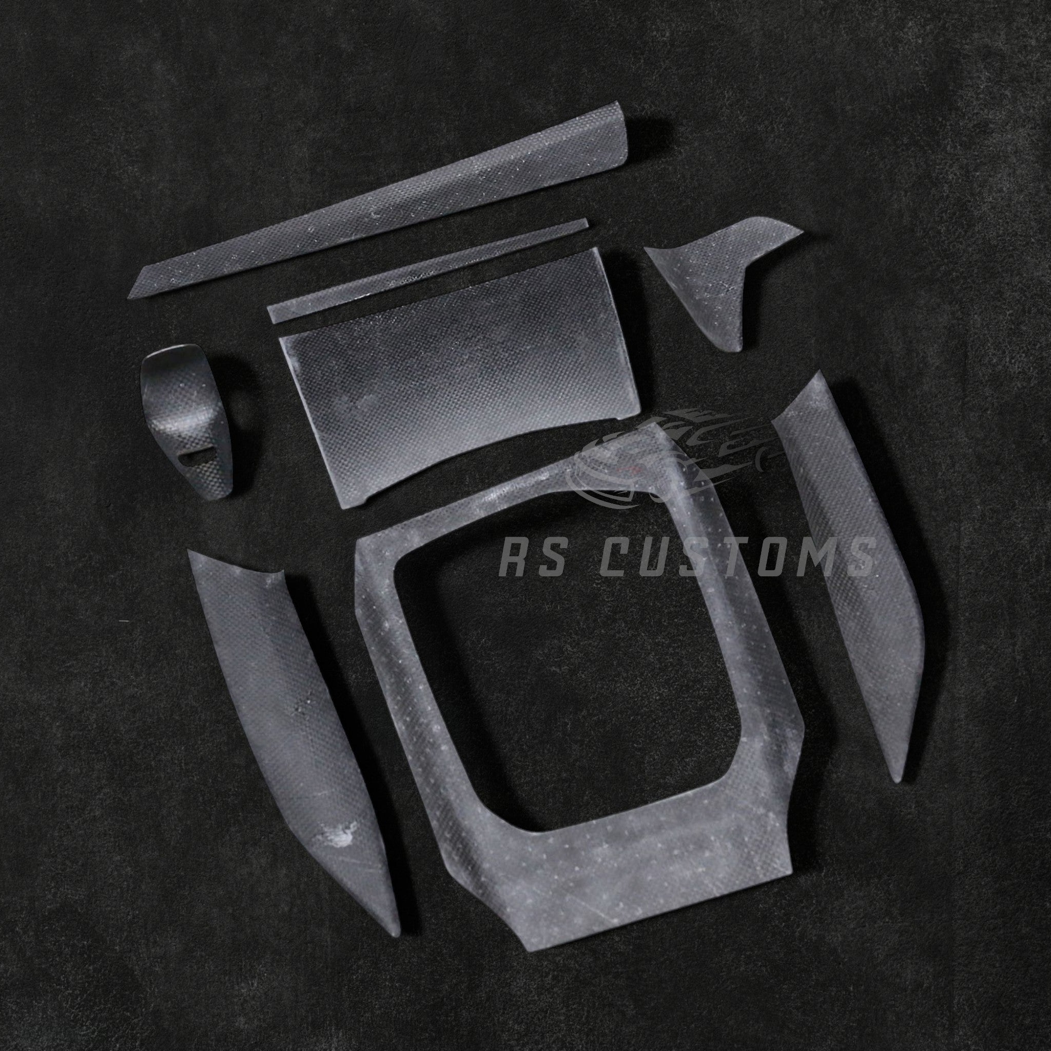 RS CUSTOMS carbon fiber interior trim kit for car dashboard and console. High-gloss finish with intricate weave pattern.
